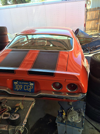 Surrounded by parts. The smell of oil, grease, and metal was pungent.